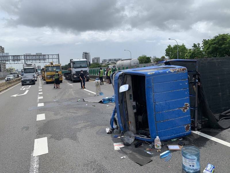 國道1號南下372.3公里今日上午10點多，發生小貨車與拖板車碰撞事故，導致小貨車側翻，車上2人受傷送醫。（國道警方提供）